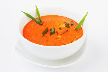 traditional spicy Thai Tom Yam soup on a wooden table