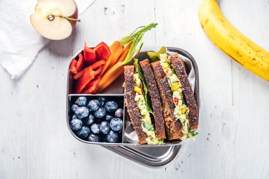 Food: Lunchbox with sandwich, vegetables and fruits