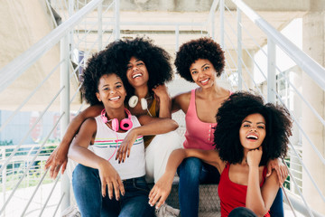 Afro women friends hanging out in the city