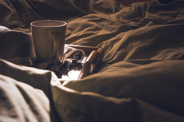 Close up of cup of tea in bed