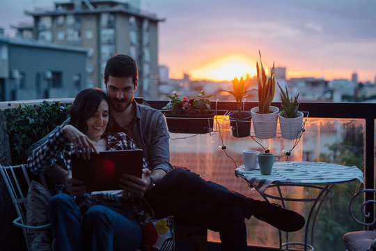 Couple looking at table computer on the house terrace