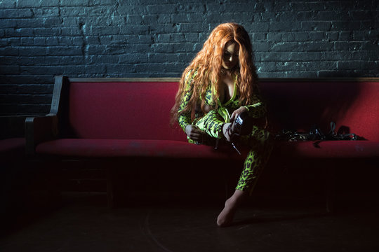 Drag Queen Putting on Strap-On Boots