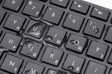 drops of water on a black keyboard