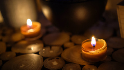 Close-up of burning tealight candle on table in home.
