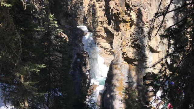 Frozen Waterfall is Starting to Melt in the Distance. Johnston Canyon in  Banff, Alberta, Canada. 