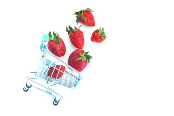 fresh ripe strawberries in a tiny supermarket trolley , still life