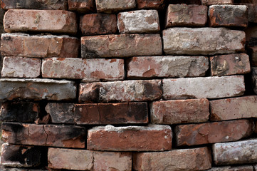 Wall of old bricks. Texture. A pile of building bricks
