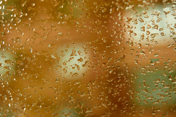 Natural water drops on the glass. orange tones.