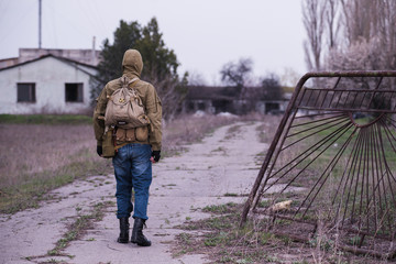 Lonely man walking to waste zone