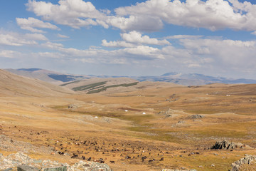 Man riding a motorbike in the steppes of Mongolia, on the hills of Mongolia