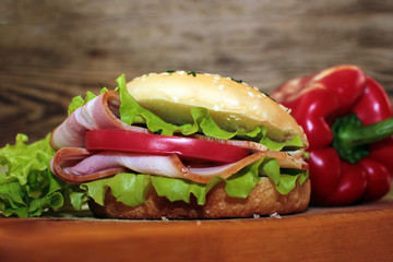 Delicious hamburger sandwich with meat, cheese and fresh vegetables.  or a sandwich for breakfast or lunch.  Juicy Cheeseburger