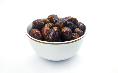 Fresh dates in white bowl. Love for a healthy vegan food concept.