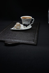 traditional Turkish coffee with Turkish delight. heart shaped saucers and traditional Turkish coffee on black granite   tray in black background. Coffee cups and saucers with the symbols of istanbul.
