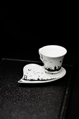 traditional Turkish coffee with Turkish delight. heart shaped saucers and traditional Turkish coffee on black granite   tray in black background. Coffee cups and saucers with the symbols of istanbul.
