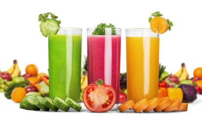 Colorful ripe vegetables and fruits and juice in a glass