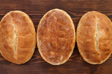 Fresh homemade wheat bread on  wooden table.