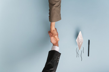 Top view of businessman and businesswoman shaking hands in agreement and collaboration