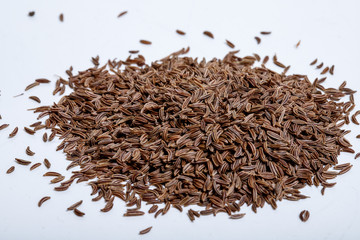 Pile of cumin seeds isolated on white background