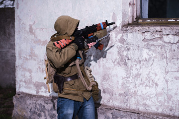 Rebel aiming with AK to window