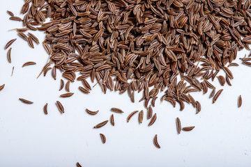 Pile of cumin seeds isolated on white background