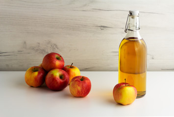A glass bottle of apple juice, cider, vinegar