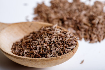 Pile of cumin seeds isolated on white background