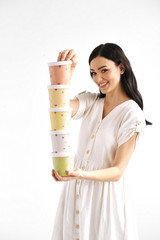 Girl holding a tower of colored paper boxes.