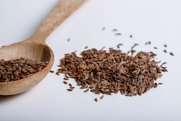 Pile of cumin seeds isolated on white background