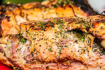Fresh, delicious grilled porchetta. Grilling porchetta on BBQ. Closeup of a porchetta on a grill, detail on the crunchy skin