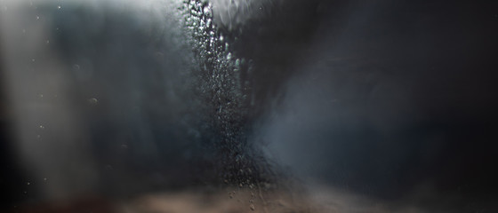 Small drops of water beaten by the sun in the counter-jour form gray abstractions