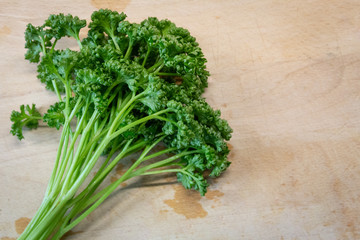 A bunch of parsley on a wooden board