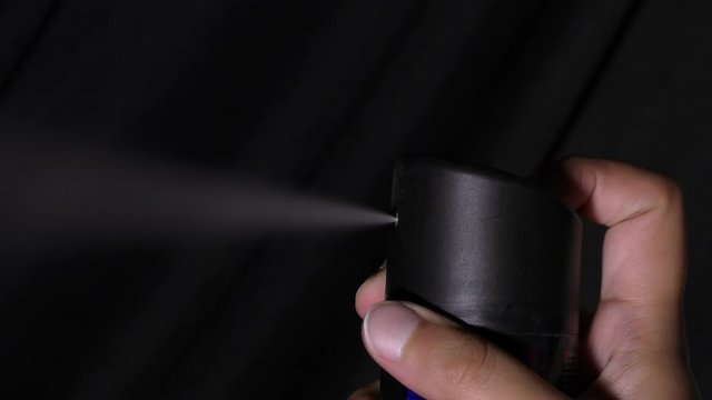 Gas stream coming out of deodorant being pressed with fingers