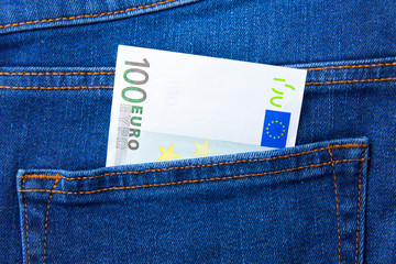 A bill of 100 euros in the pocket of jeans trousers
