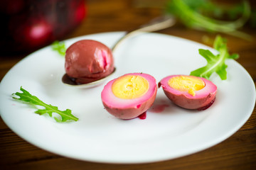 marinated chicken eggs in beetroot marinade in a plate