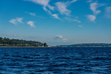 Mount Ranier appears to float above Elliot Bay and the hills near Seattle, Washington on a sunny...