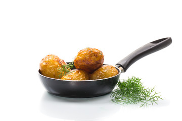 whole fried young potatoes in a pan