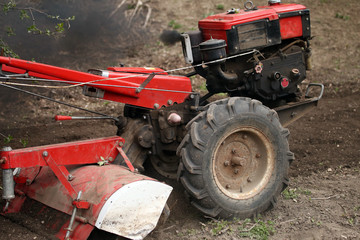 a walk-behind tractor in a field
