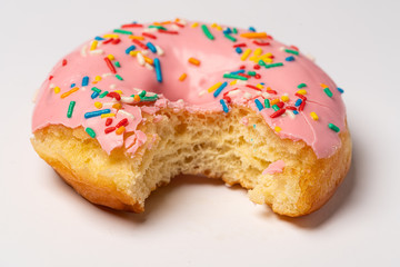 bitten donut with sprinkles isolated
