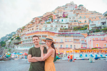 Summer holiday in Italy. Young couple in Positano village on the background, Amalfi Coast, Italy
