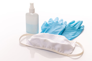 Obraz na płótnie Canvas Set of protecting disposable ntiviral various filtering safety face masks, gloves, sanitizer for hands on white background.