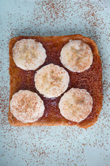 Tasty breakfast. Toast with jam and bananas on blue plate