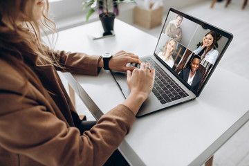 Video call. Remote work. A girl work from home. She communicate via video communication with...