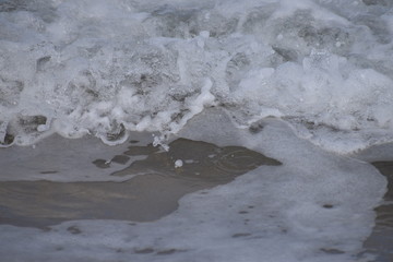 sea foam cresting over wave