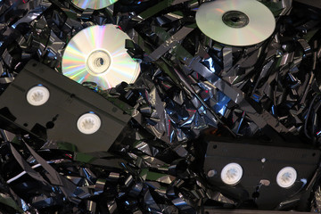 Storage media: video tapes and laser discs lying on a magnetic tape