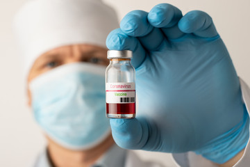 Scientist holds bottle with coronavirus vaccine. World-leading laboratory created vaccine to tackle Covid-19 virus