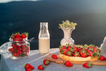 Table on the nature with a view of the mountains in the setting sun.