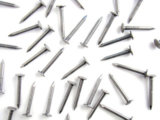 Small nails scattered on a white background