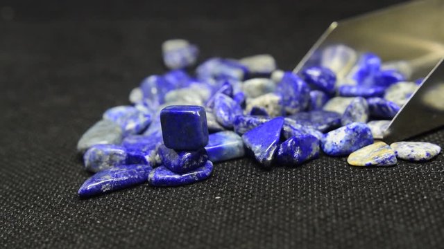 Lapis Is a beautiful natural gemstone on a wooden floor	
