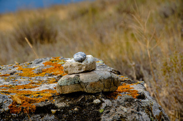 Cairn in the mountains on a large stone.