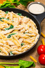 Chicken Alfredo Pasta with Spinach. Selective focus.